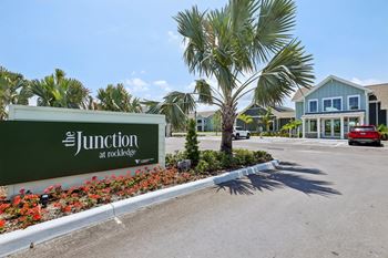 The junction at rockledge sign in front of a building.